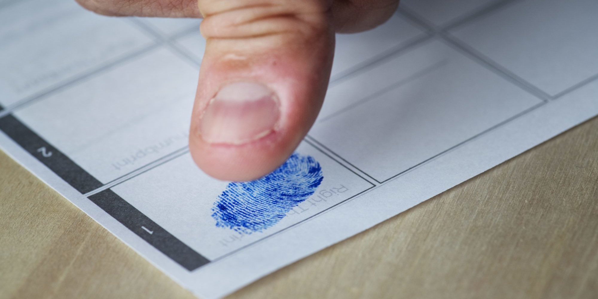 closeup-of-fingerprint-on-paper-PHS4W76-min